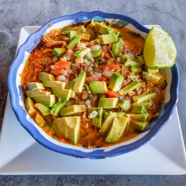 El Cabo Restaurant's Mexican soup with shredded chicken, avocado, pico de gallo, and a lime wedge.