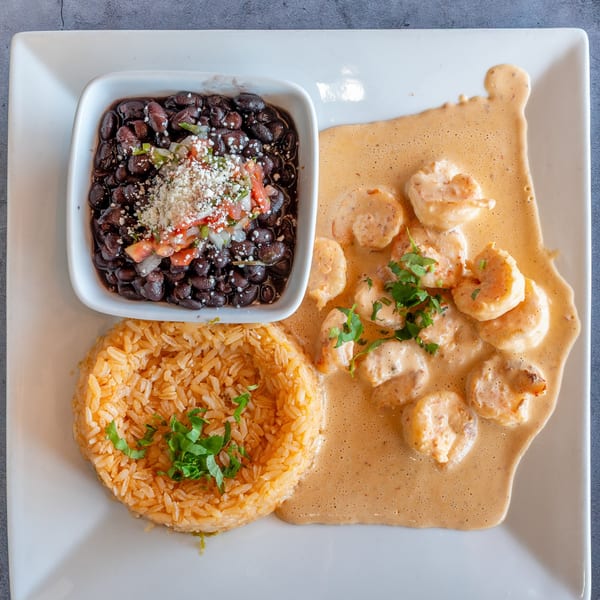 El Cabo Restaurant's creamy shrimp dish with black beans topped with pico de gallo and rice.